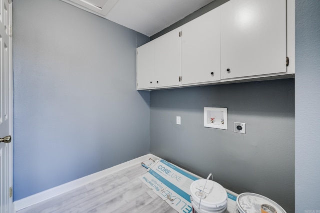 clothes washing area with hookup for a washing machine, cabinets, hookup for an electric dryer, and light hardwood / wood-style floors