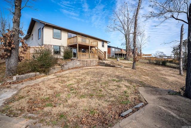 rear view of property with a wooden deck