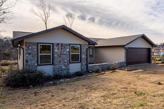 single story home with a garage and a yard