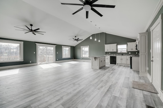 unfurnished living room featuring ceiling fan, sink, and light hardwood / wood-style flooring