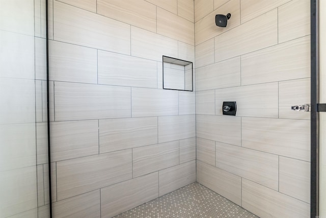 bathroom with a tile shower