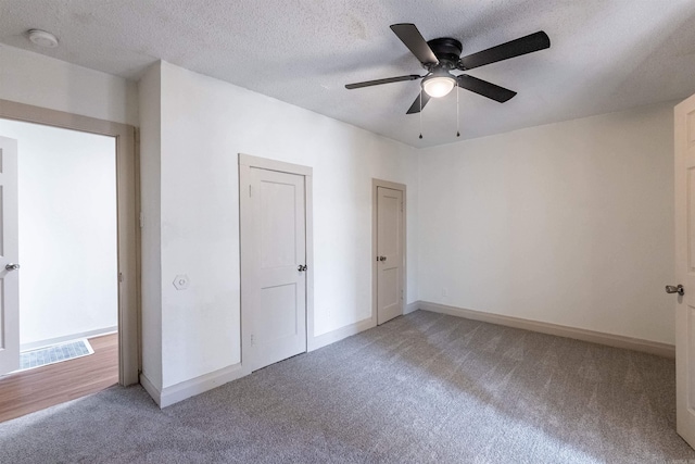 unfurnished bedroom featuring a textured ceiling, ceiling fan, and carpet flooring