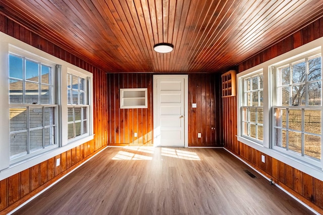 unfurnished sunroom with wood ceiling