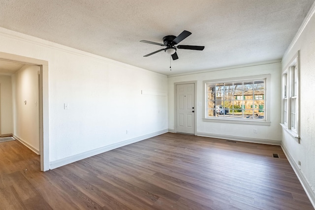 unfurnished room with wood-type flooring, crown molding, and a textured ceiling