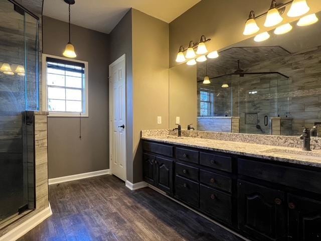 bathroom with vanity, wood-type flooring, and a shower with door