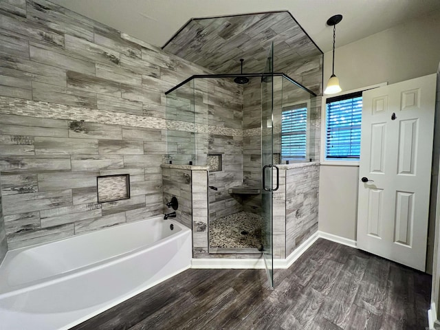 4112 Stephanie Ln, Jonesboro, AR 72401 - bathroom featuring wood finished floors, a stall shower, baseboards, and a bath