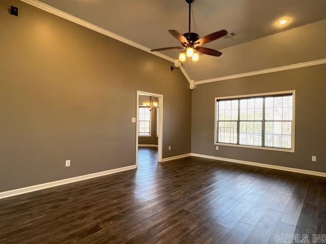 spare room with dark hardwood / wood-style flooring, ornamental molding, lofted ceiling, and ceiling fan