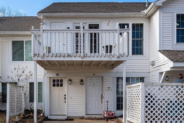 view of exterior entry with a balcony