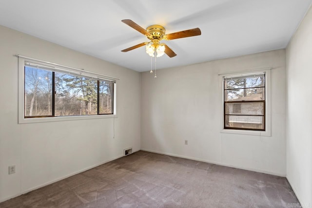 spare room featuring ceiling fan and carpet flooring