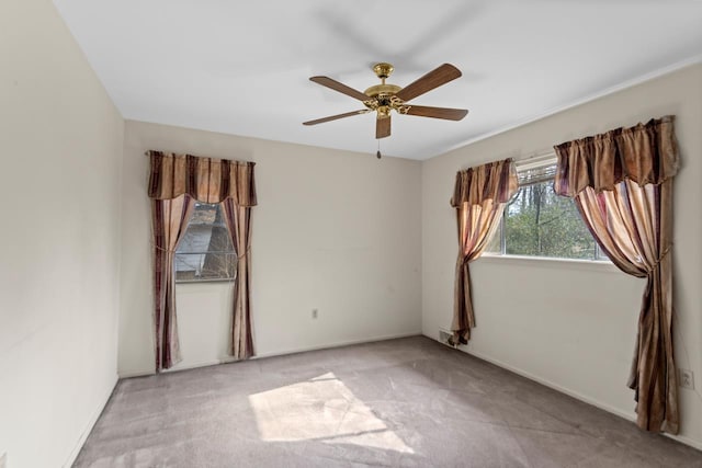 carpeted empty room featuring ceiling fan