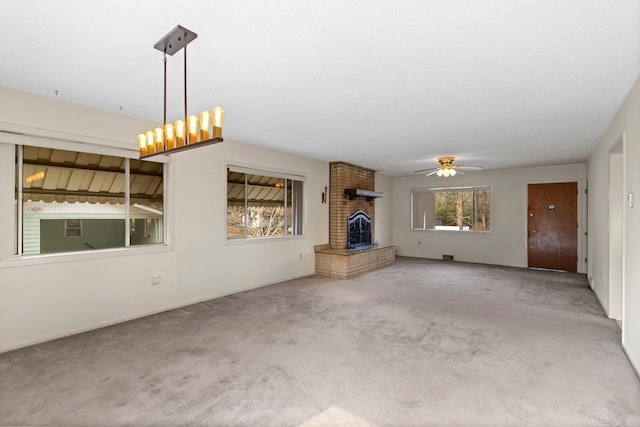 unfurnished living room featuring ceiling fan and carpet