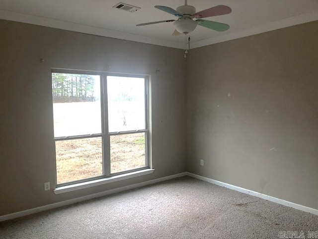 carpeted empty room with ceiling fan and ornamental molding