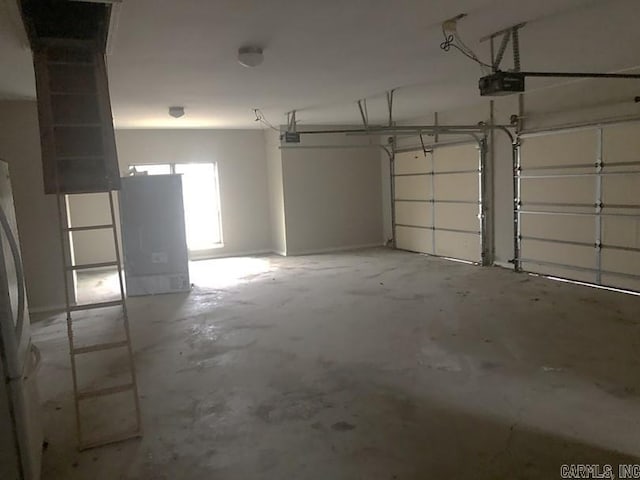 garage with a garage door opener and white refrigerator