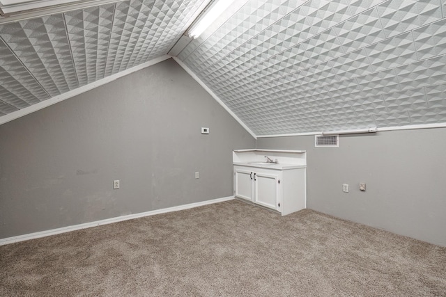 bonus room featuring lofted ceiling, light colored carpet, and sink