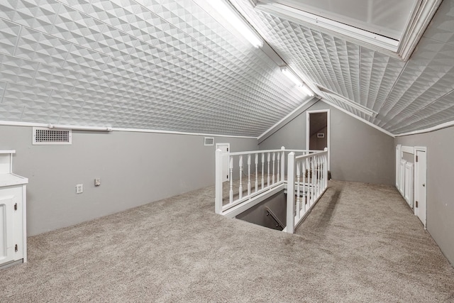 additional living space with light colored carpet and lofted ceiling