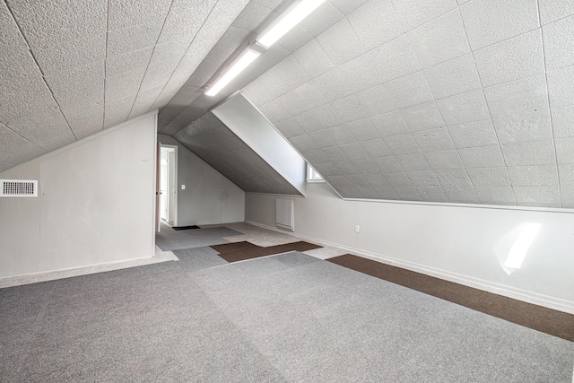 bonus room featuring carpet floors and vaulted ceiling