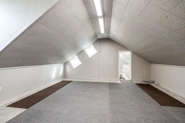 additional living space featuring carpet floors and lofted ceiling