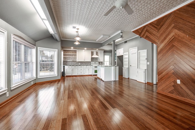 unfurnished living room featuring lofted ceiling, ceiling fan, dark hardwood / wood-style flooring, and ornamental molding