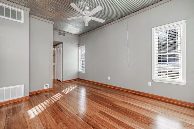 empty room featuring ceiling fan and hardwood / wood-style floors