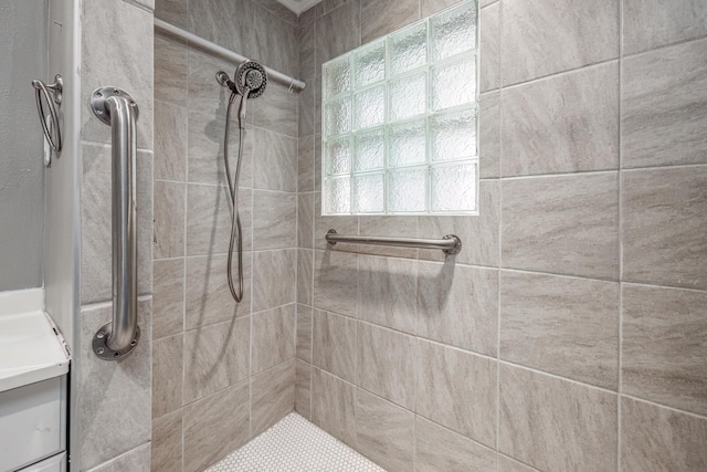 bathroom with tiled shower