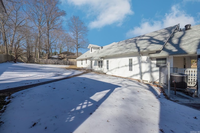 yard layered in snow with central AC unit