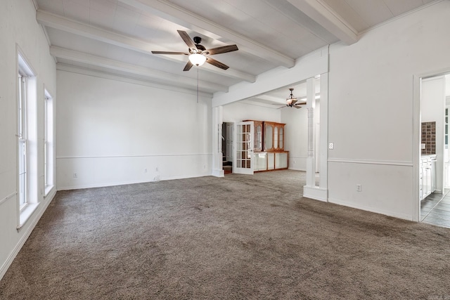 unfurnished living room featuring dark colored carpet, beam ceiling, and ceiling fan