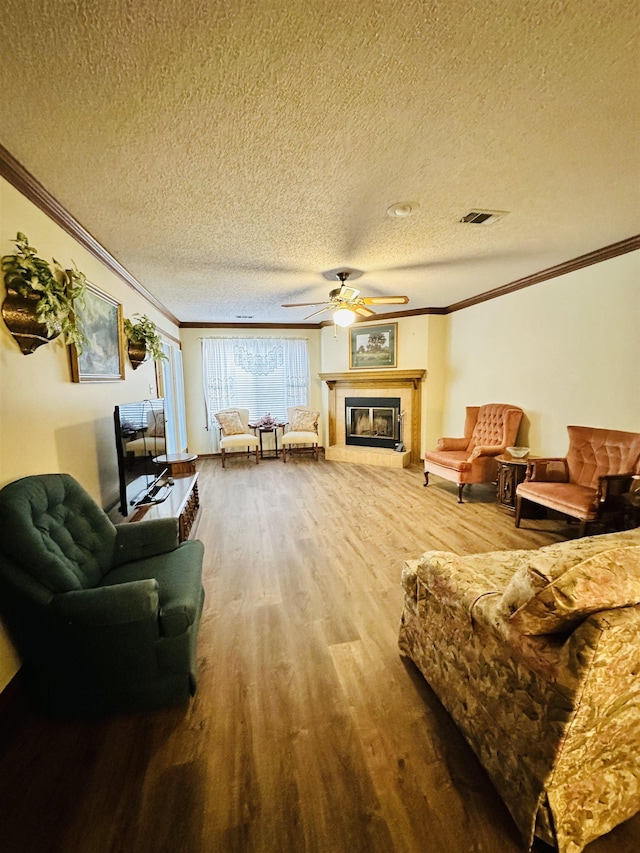 living room with a textured ceiling and crown molding