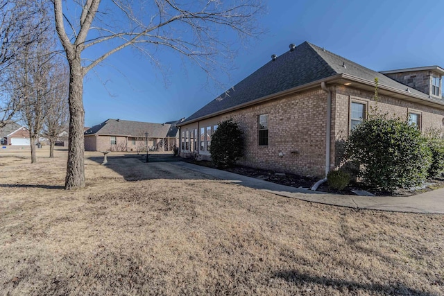 view of side of property with a lawn