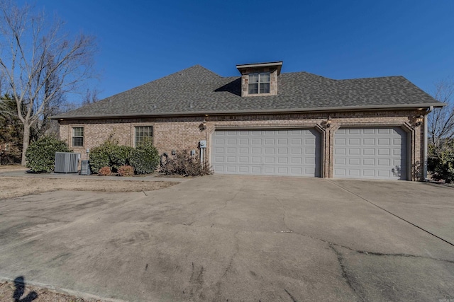 view of front of house with cooling unit and a garage