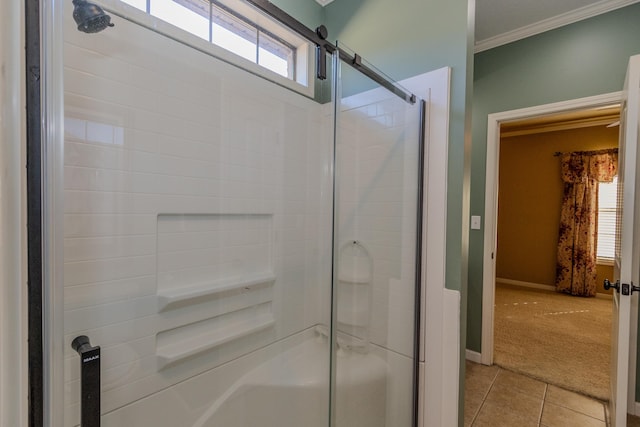 bathroom with enclosed tub / shower combo, crown molding, plenty of natural light, and tile patterned floors