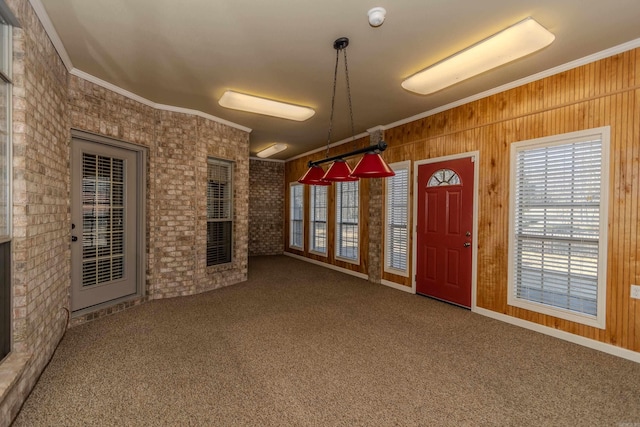 interior space with crown molding and wooden walls