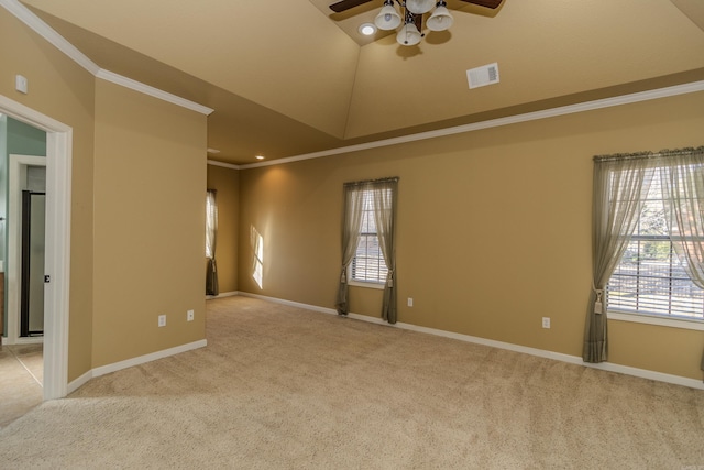 carpeted spare room with crown molding, ceiling fan, and vaulted ceiling