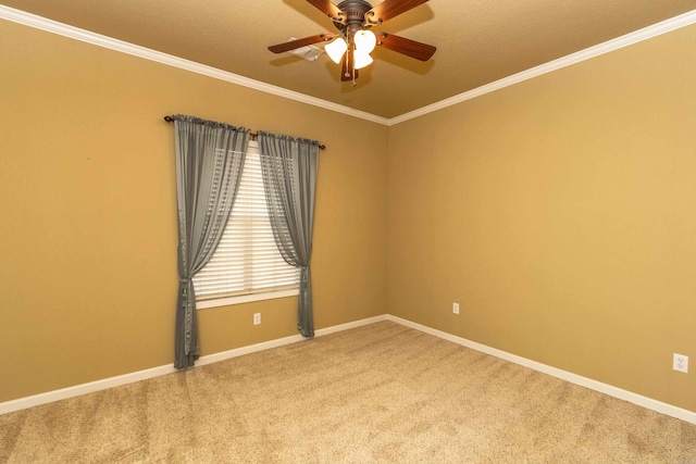 spare room featuring carpet floors, ornamental molding, and ceiling fan