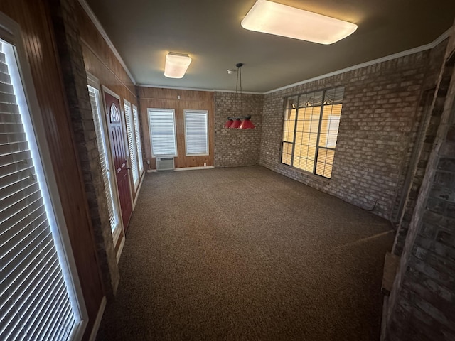 carpeted empty room with brick wall and ornamental molding