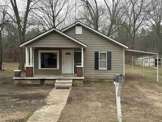 view of front of home with a carport and a porch