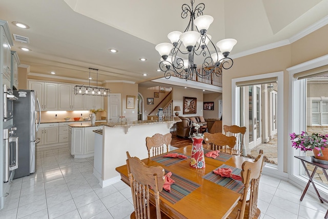 tiled dining space featuring a notable chandelier and crown molding