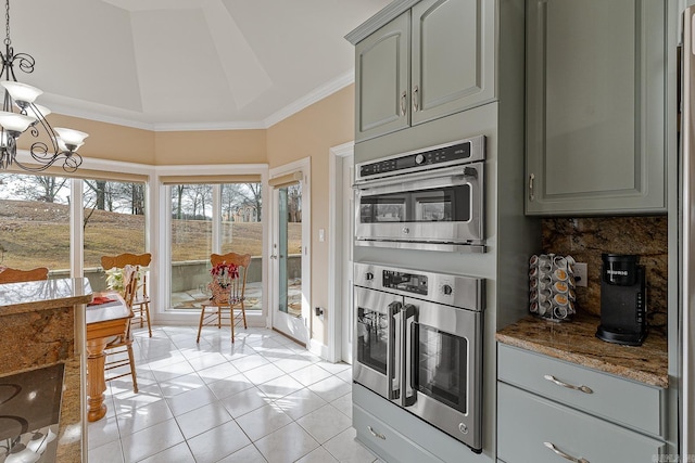 kitchen featuring double oven, dark stone counters, tasteful backsplash, light tile patterned floors, and crown molding