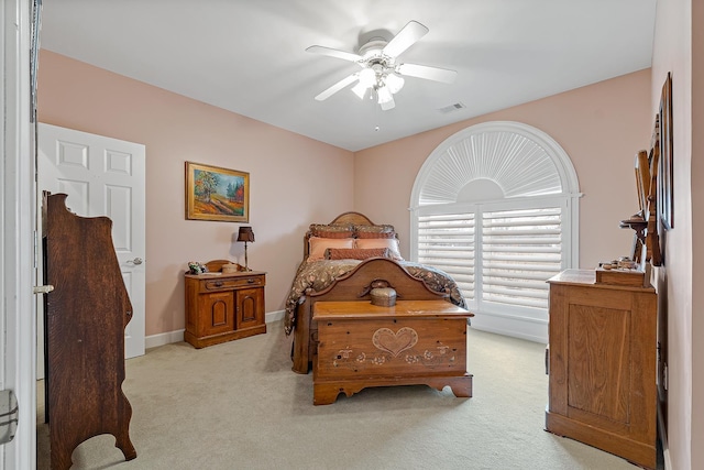 bedroom with ceiling fan and light carpet