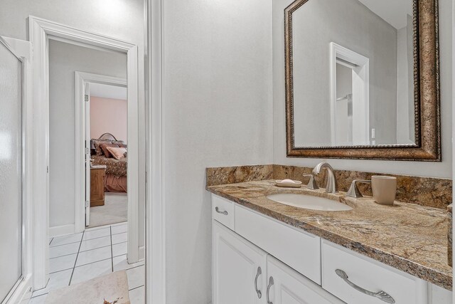 bathroom with tile patterned floors and vanity