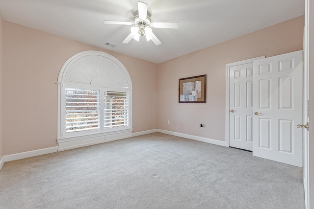 carpeted empty room with ceiling fan