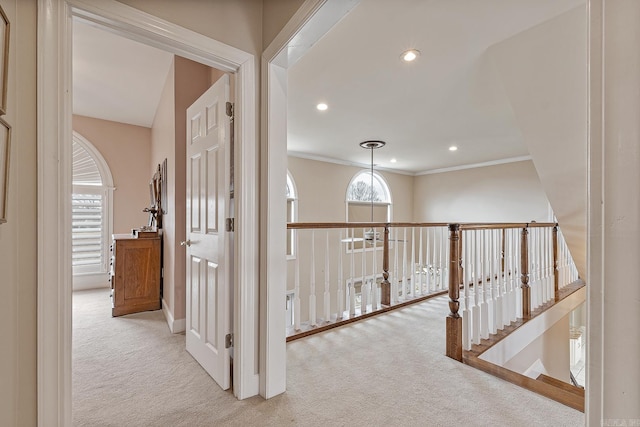 hallway featuring light colored carpet and crown molding