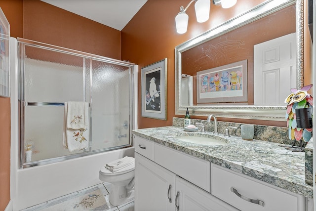 full bathroom with combined bath / shower with glass door, vanity, toilet, and tile patterned flooring