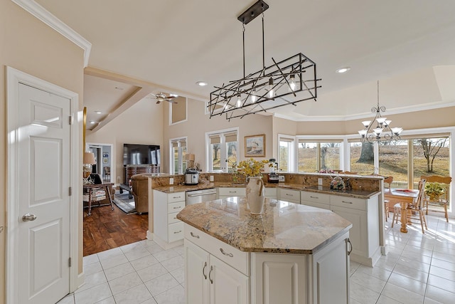 kitchen featuring pendant lighting, light tile patterned floors, kitchen peninsula, and a kitchen island