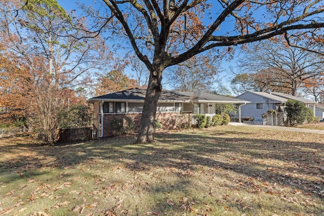 ranch-style home with a front yard