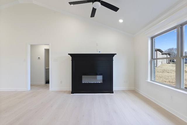 unfurnished living room with light hardwood / wood-style floors, lofted ceiling, crown molding, and a healthy amount of sunlight