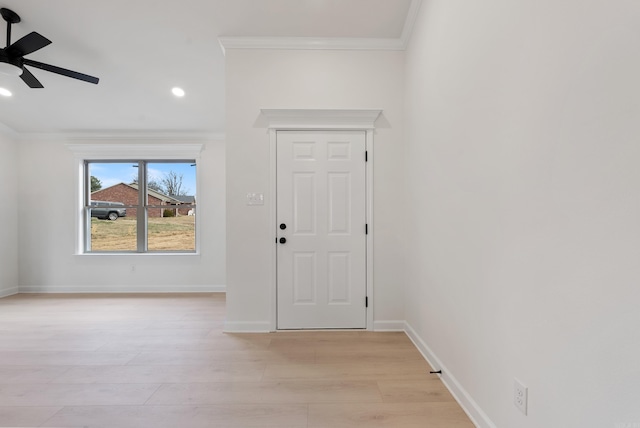 foyer entrance featuring ceiling fan, crown molding, and light hardwood / wood-style flooring