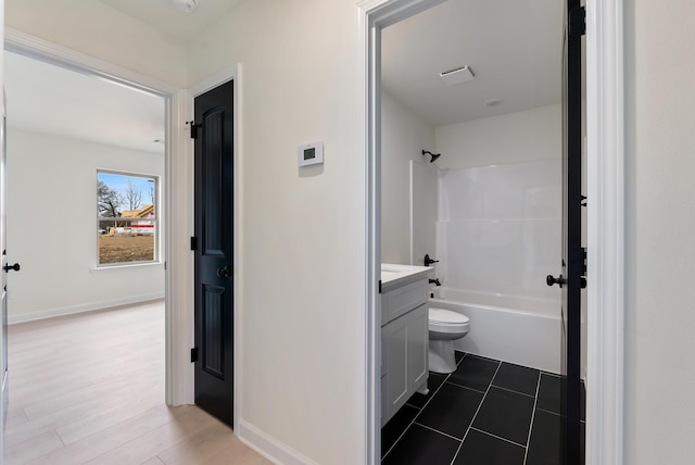 full bathroom with toilet, bathing tub / shower combination, hardwood / wood-style flooring, and vanity