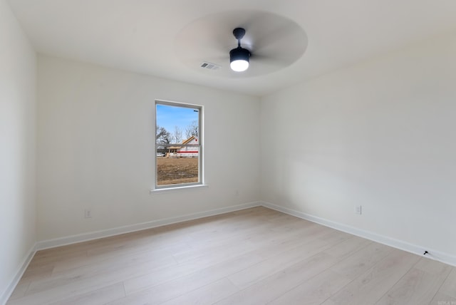 spare room featuring ceiling fan and light hardwood / wood-style flooring