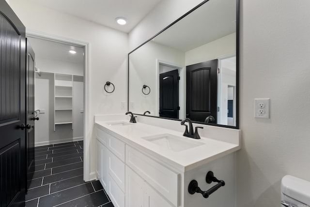 bathroom featuring toilet, vanity, and tile patterned flooring