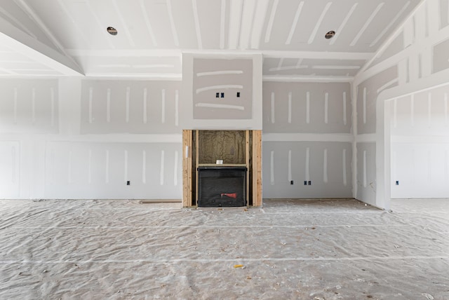 unfurnished living room featuring lofted ceiling